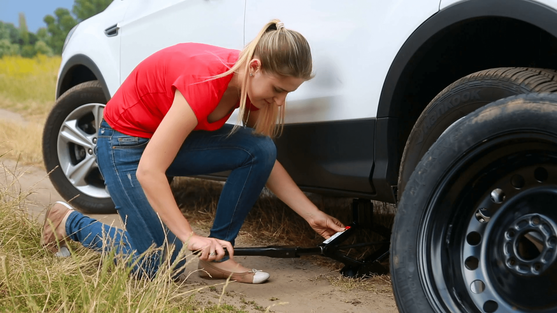 woman changing flat tire
