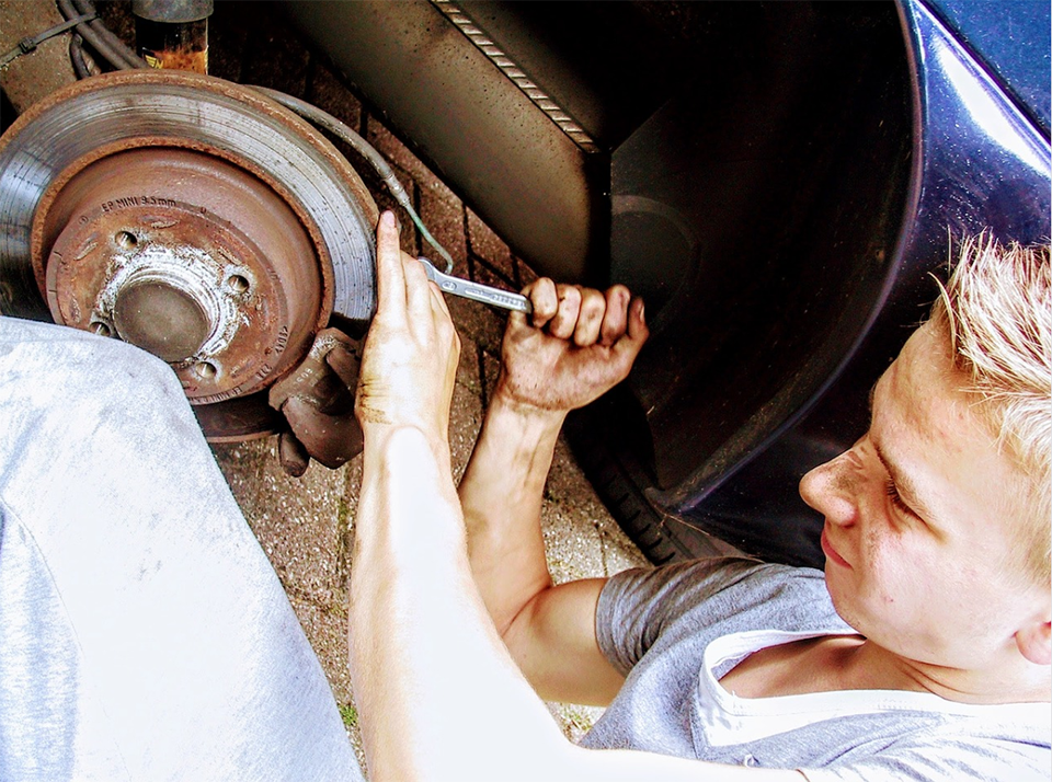 Mechanic working on transmission fluid leak