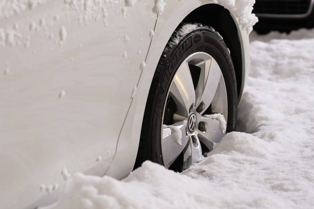 White car stuck in the snow